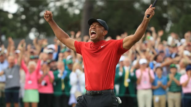 Tiger Woods (L) of the United States celebrates on the 18th green after winning the Masters at Augusta National Golf Club on April 14, 2019 in Augusta, Georgia.